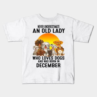 Never Underestimate An Old December Lady Who Loves Dogs Kids T-Shirt